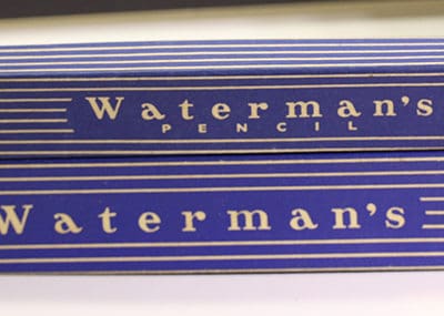 Two boxes of waterman's pencils on a table.