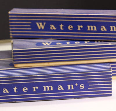 Three boxes of waterman's soap sitting on a table.