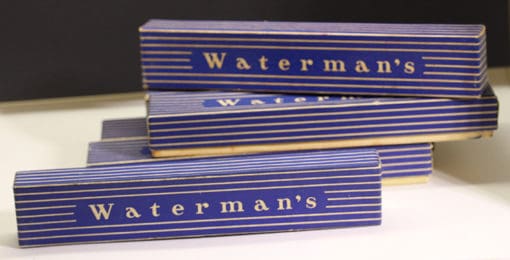 Three boxes of waterman's soap sitting on a table.