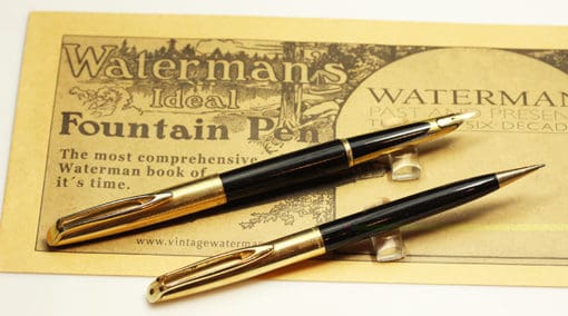 Two fountain pens on a piece of paper.