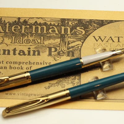 Two fountain pens on top of a piece of paper.