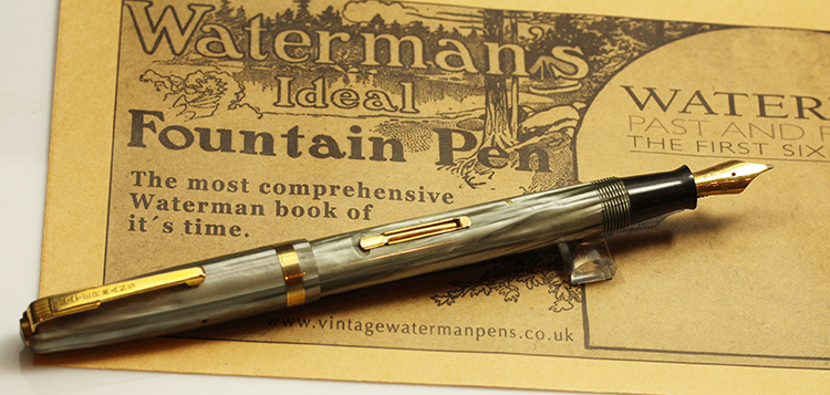 A fountain pen sitting on top of a piece of paper.